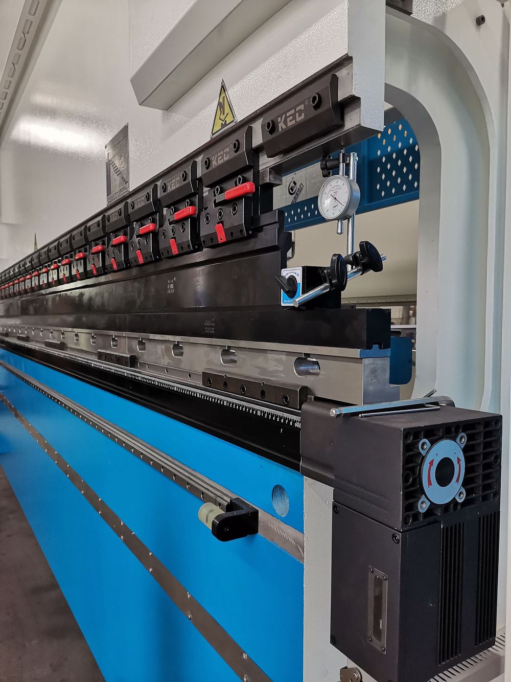 Press brake ram with clamping system holding punch tooling and backgauge ruler